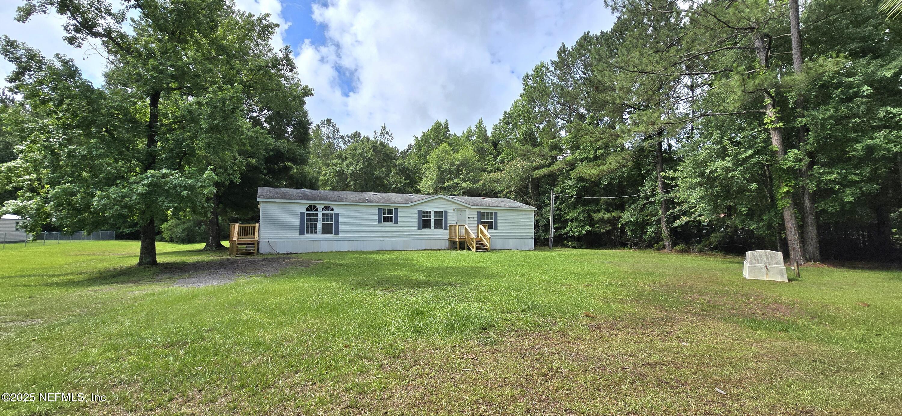 45028 Musslewhite Road Callahan, FL 32011 - Photo 1 of 18 a house with a tree in front of it
