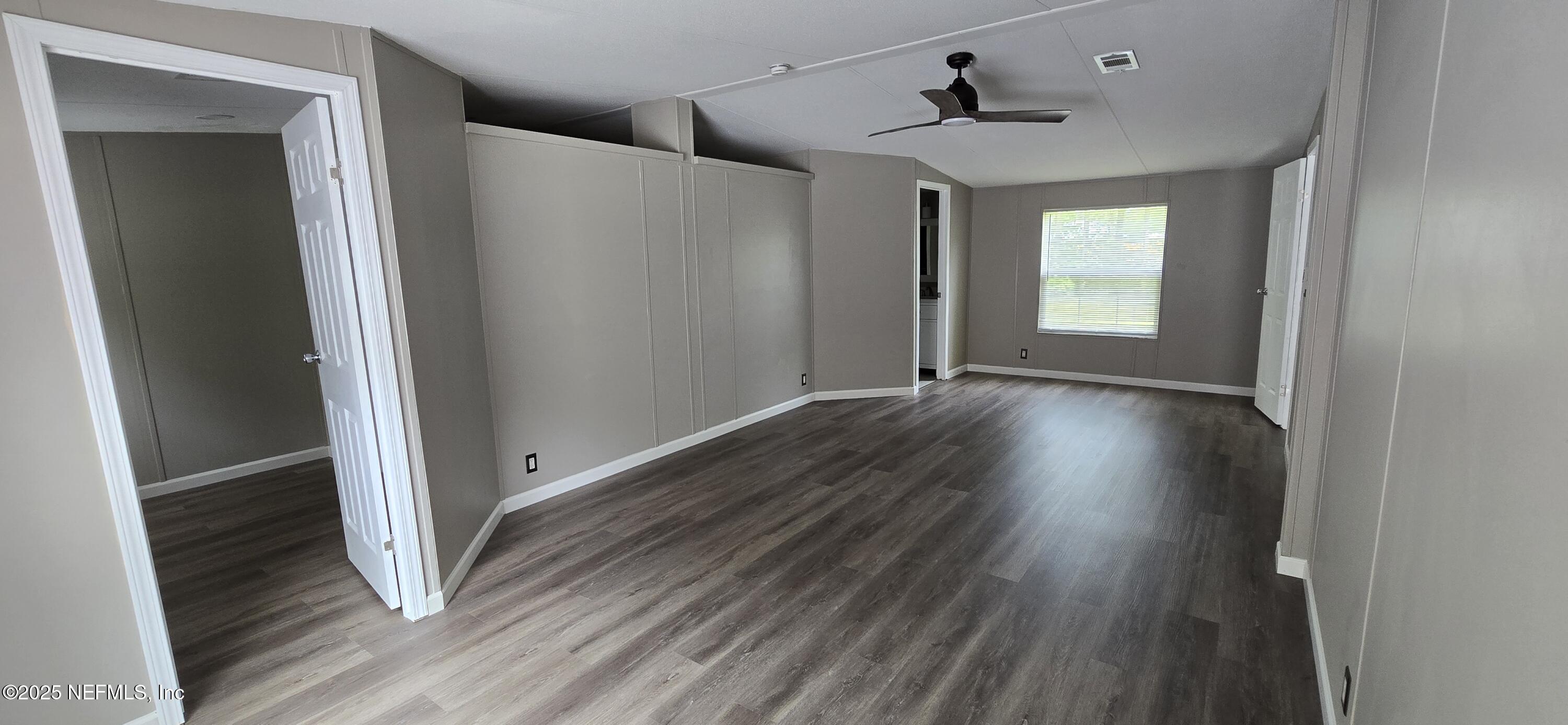 45028 Musslewhite Road Callahan, FL 32011 - Photo 11 of 18 wooden floor in an empty room with a window