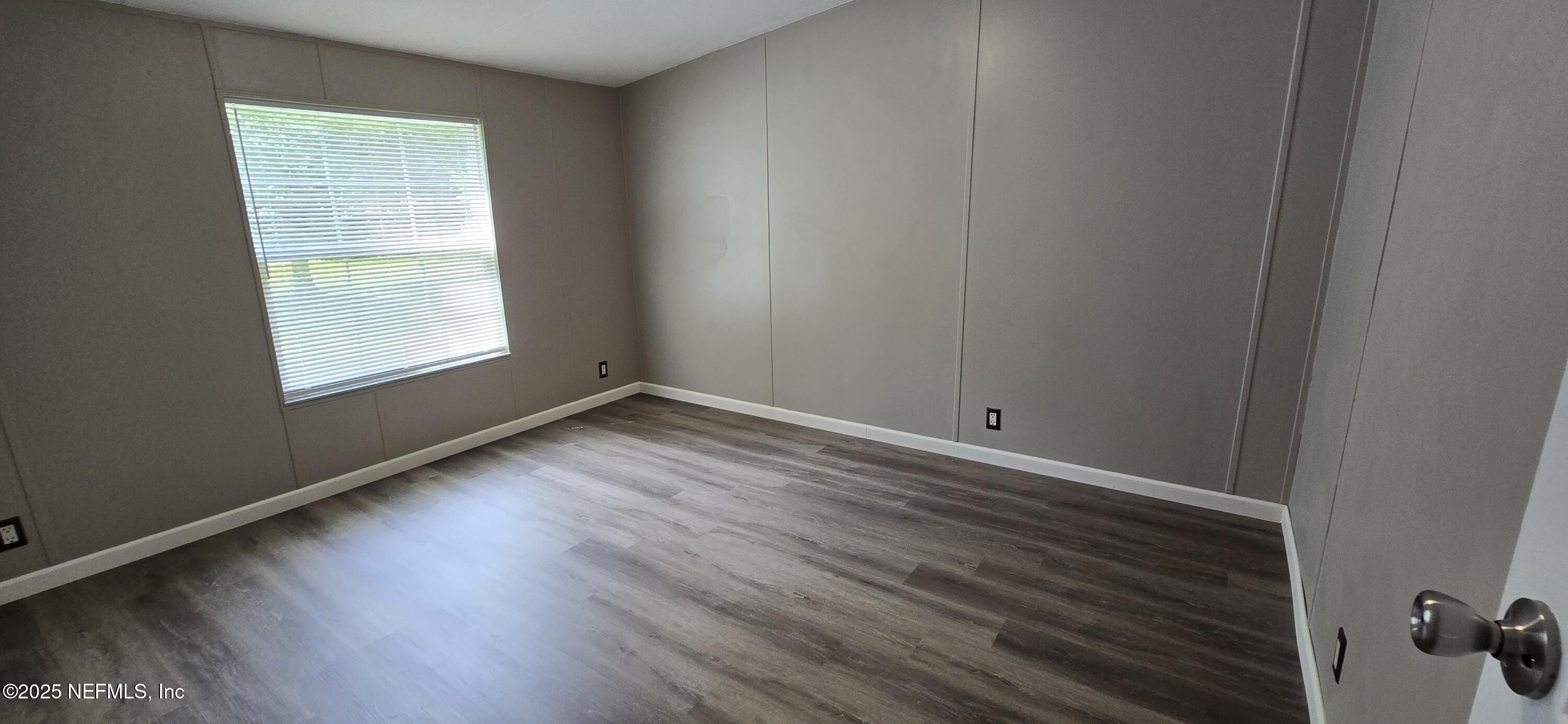 45028 Musslewhite Road Callahan, FL 32011 - Photo 14 of 18 an empty room with wooden floor and windows