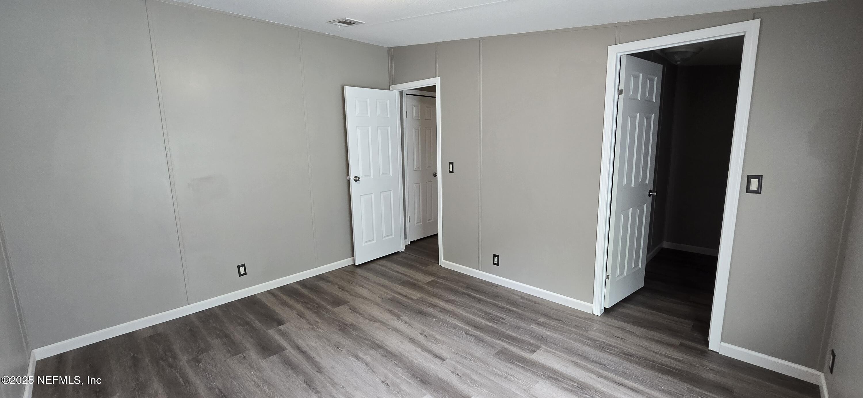 45028 Musslewhite Road Callahan, FL 32011 - Photo 16 of 18 a view of an empty room with closet and wooden floor