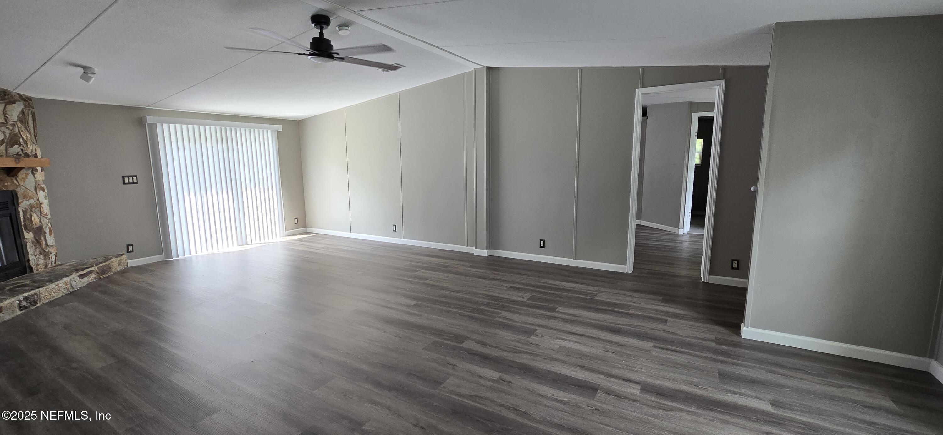 45028 Musslewhite Road Callahan, FL 32011 - Photo 6 of 18 wooden floor in an empty room with a window