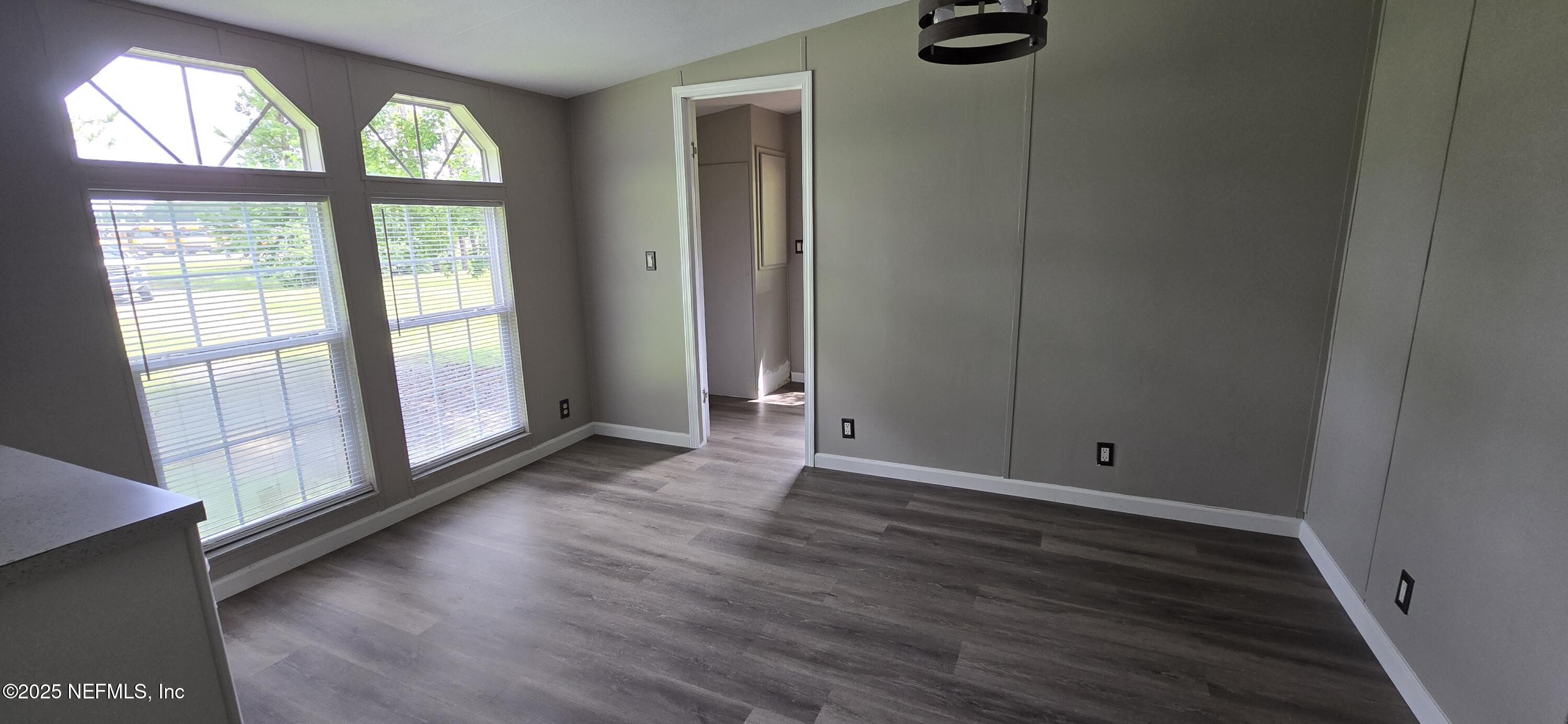 45028 Musslewhite Road Callahan, FL 32011 - Photo 9 of 18 an empty room with wooden floor and windows