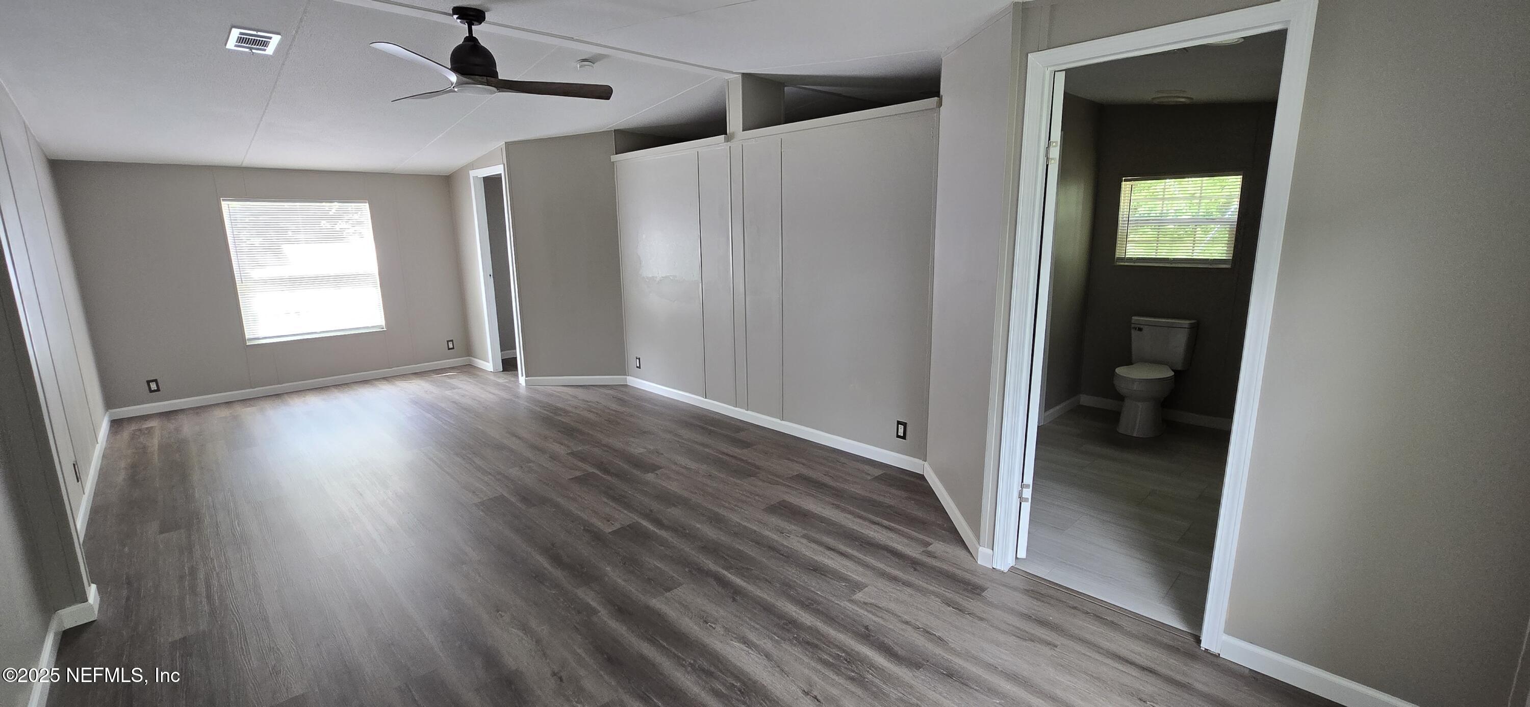 45028 Musslewhite Road Callahan, FL 32011 - Photo 10 of 18 a view of hallway with bathroom and wooden floor