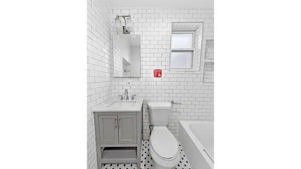 a view of a bathroom with wooden floor and a sink