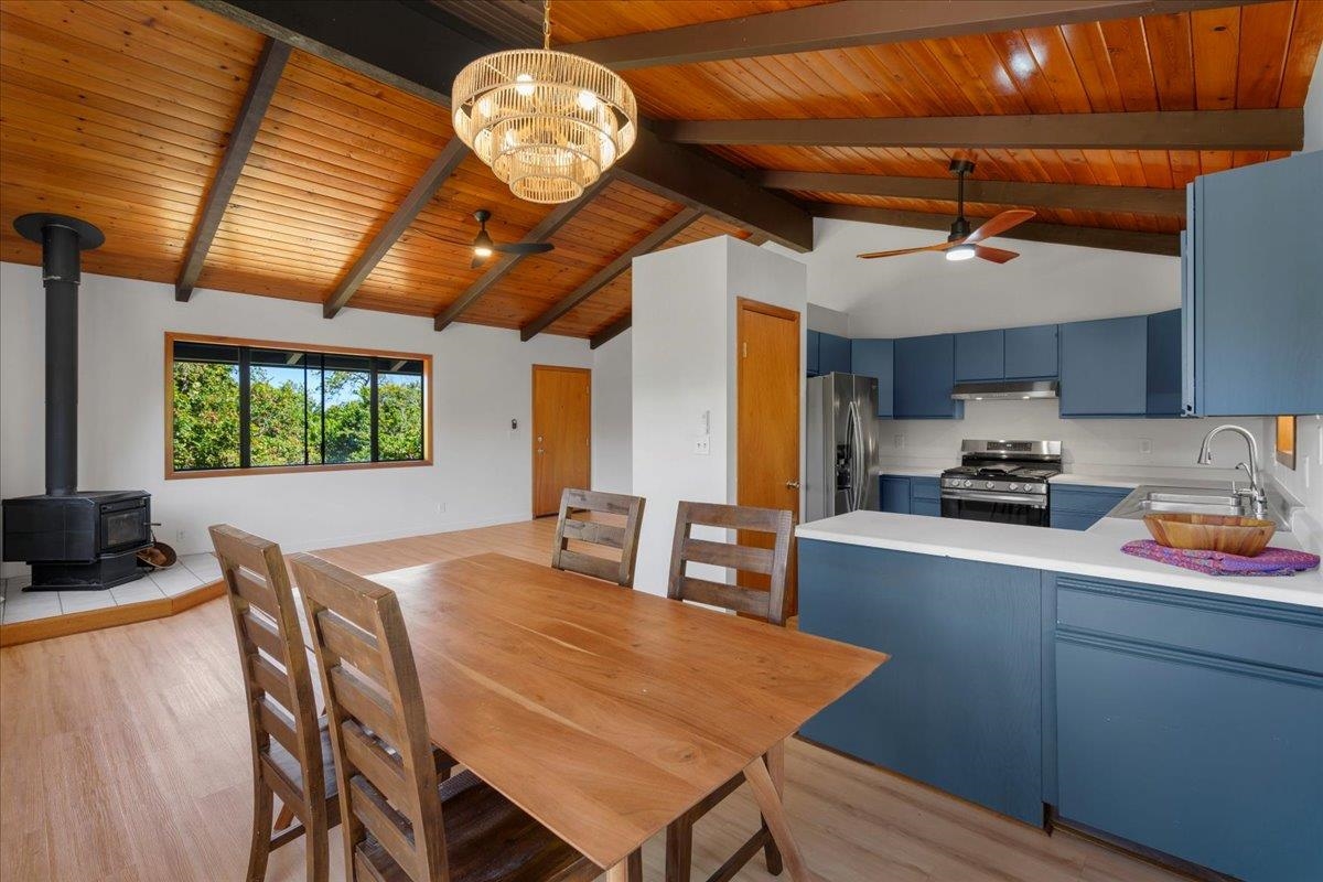 2130 Kauhikoa Road, Unit A Haiku, HI 96708 - Photo 13 of 43 a kitchen with a wooden table and chairs