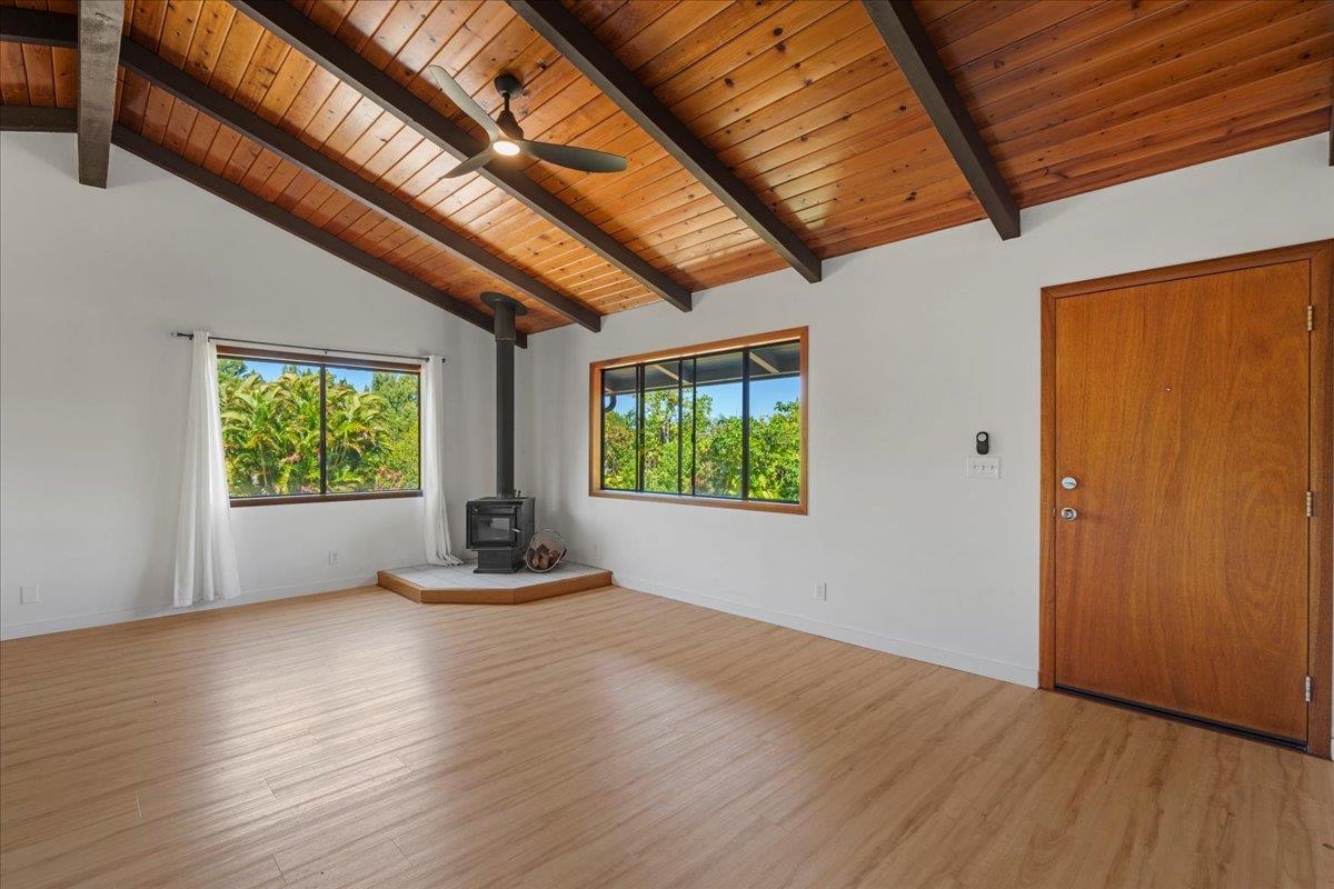 2130 Kauhikoa Road, Unit A Haiku, HI 96708 - Photo 14 of 43 a view of room with wooden floor and windows