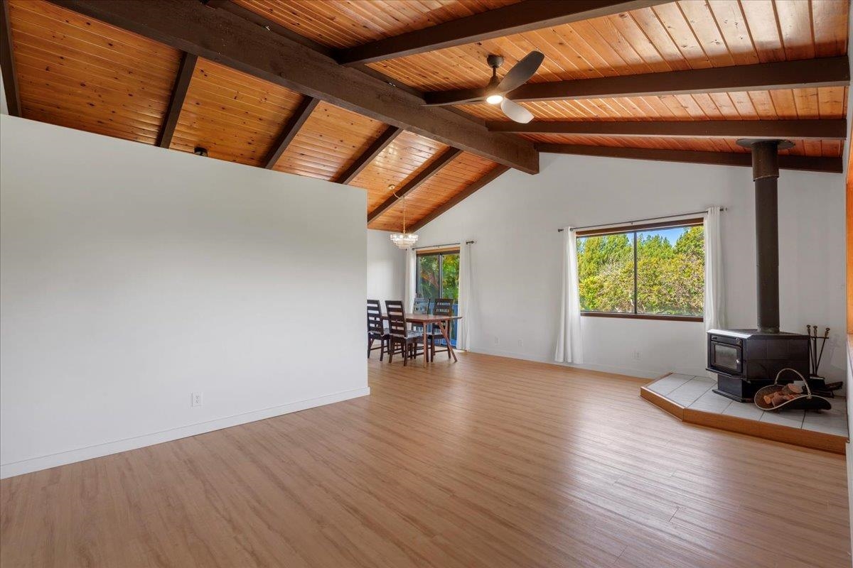 2130 Kauhikoa Road, Unit A Haiku, HI 96708 - Photo 16 of 43 an empty room with wooden floor and windows