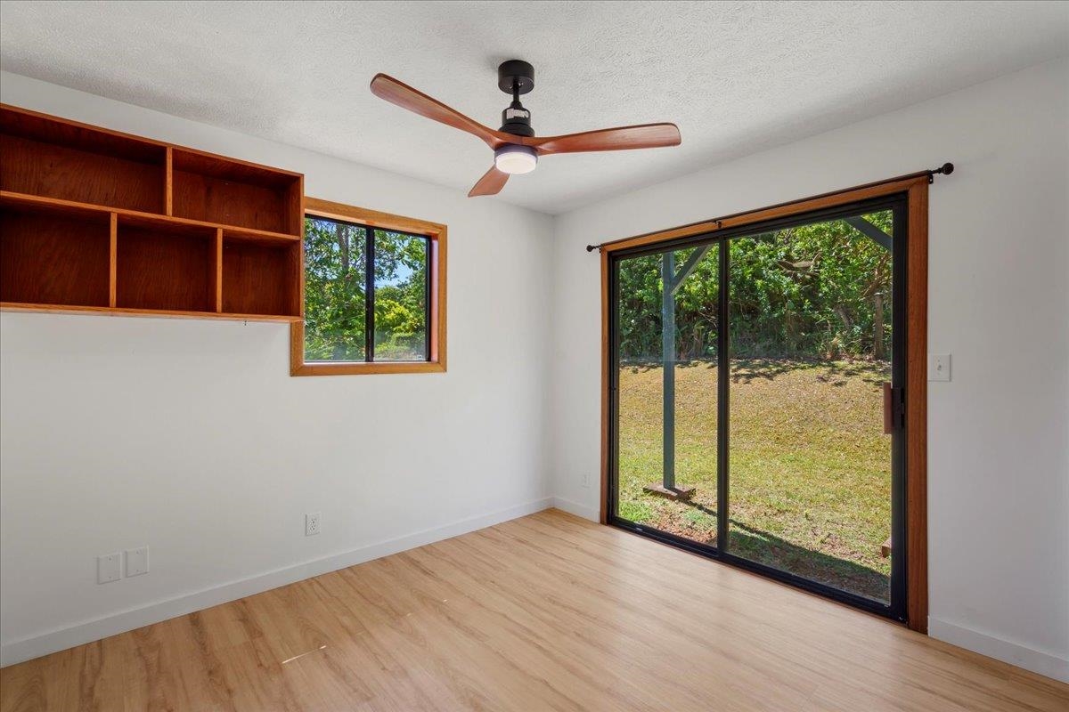 2130 Kauhikoa Road, Unit A Haiku, HI 96708 - Photo 22 of 43 a view of empty room with wooden floor and fan