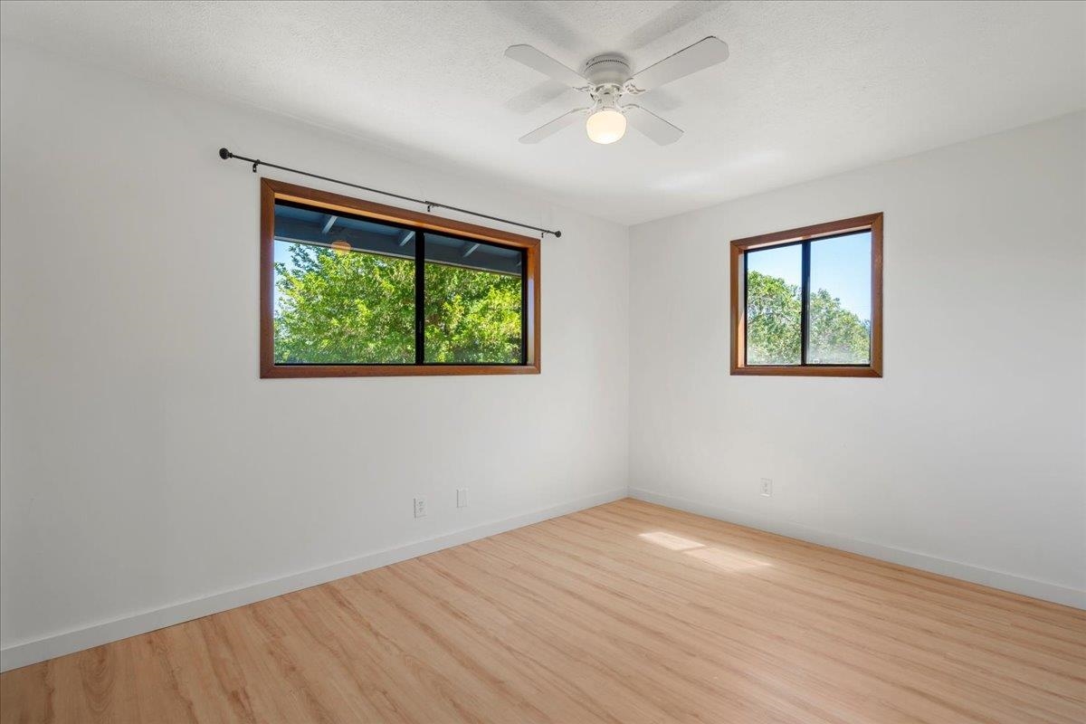 2130 Kauhikoa Road, Unit A Haiku, HI 96708 - Photo 29 of 43 a view of empty room with wooden floor and fan
