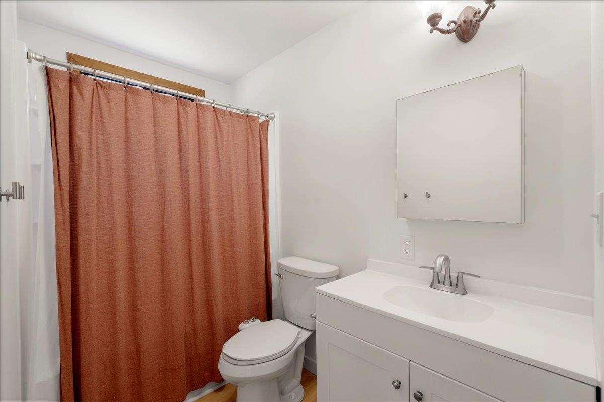 2130 Kauhikoa Road, Unit A Haiku, HI 96708 - Photo 30 of 43 a bathroom with a sink a toilet and shower curtain
