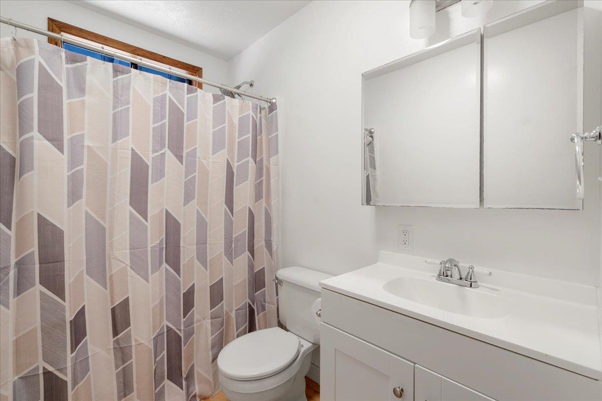 2130 Kauhikoa Road, Unit A Haiku, HI 96708 - Photo 31 of 43 a bathroom with a sink a toilet and shower curtain