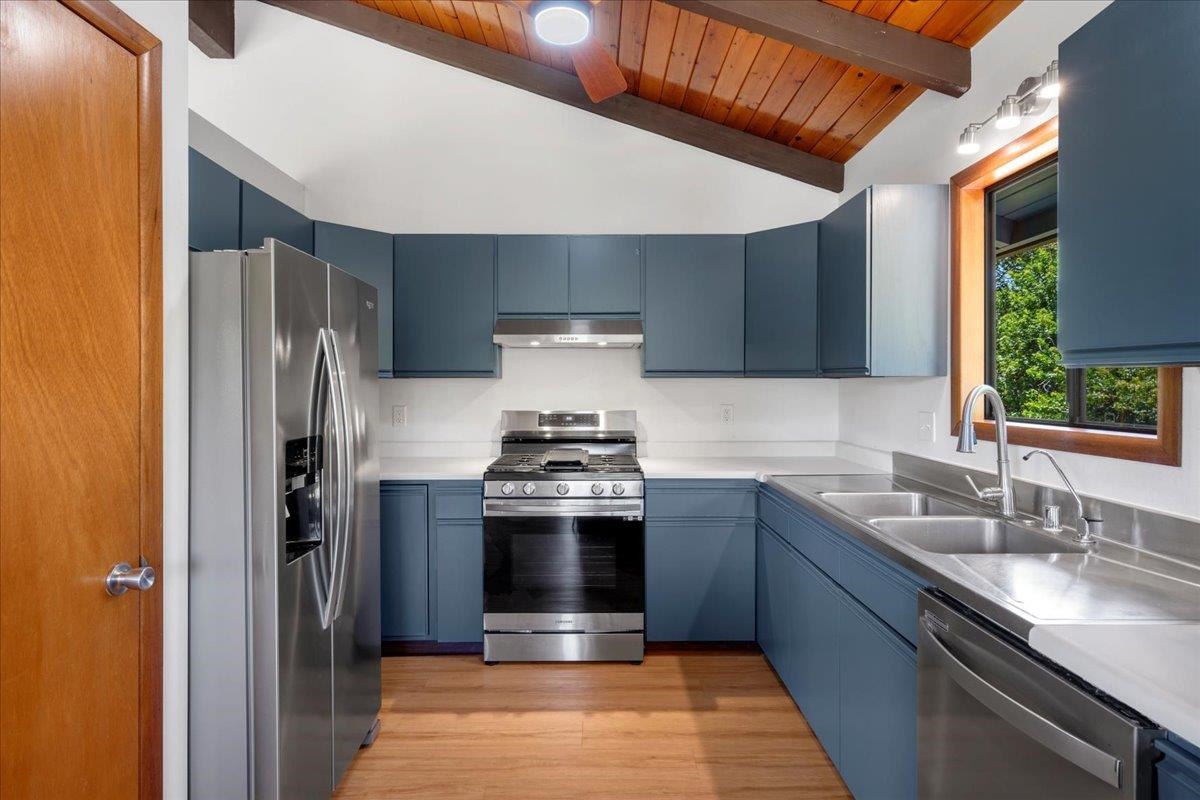 2130 Kauhikoa Road, Unit A Haiku, HI 96708 - Photo 4 of 43 a kitchen with stainless steel appliances granite countertop a refrigerator stove and sink