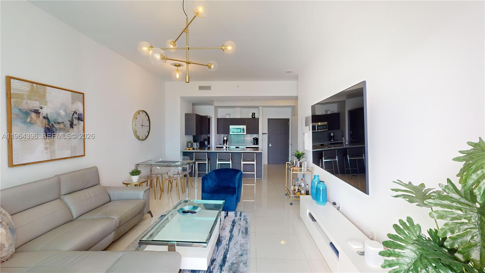 1080 Brickell Avenue, Unit 2804 Miami, FL 33131 - Photo 11 of 35 a living room with furniture and a large window