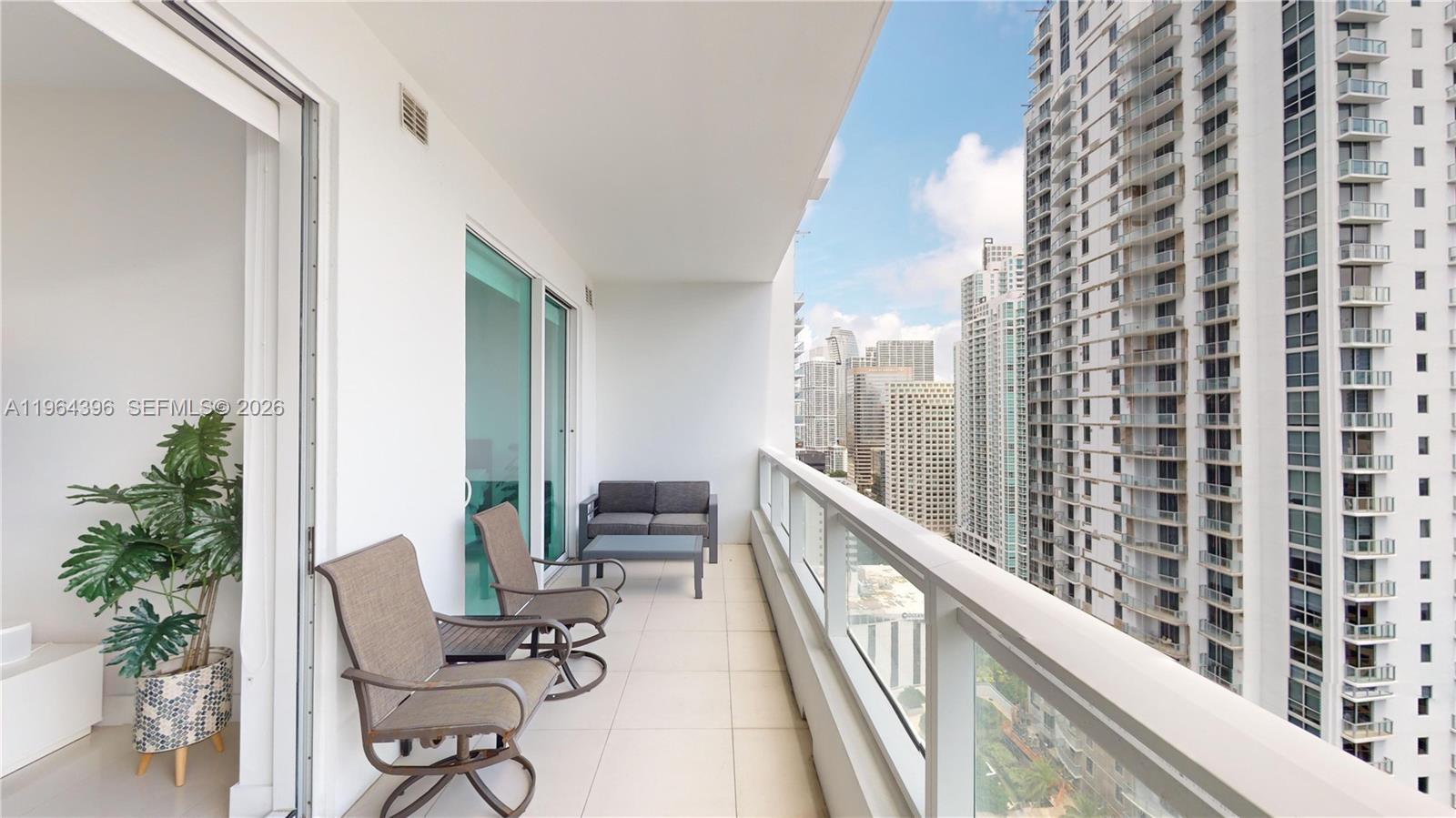 1080 Brickell Avenue, Unit 2804 Miami, FL 33131 - Photo 15 of 35 a view of a balcony with chairs