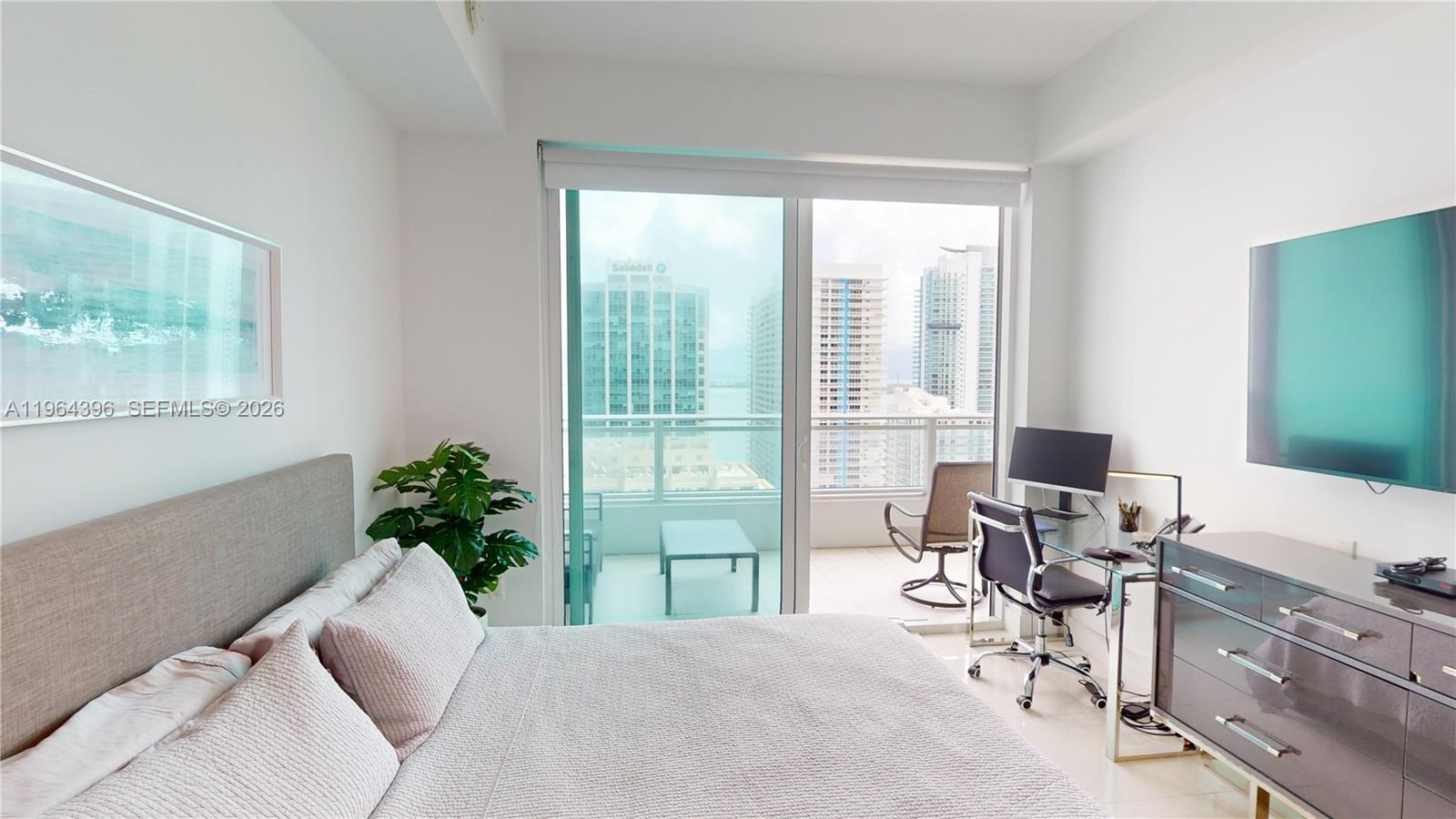 1080 Brickell Avenue, Unit 2804 Miami, FL 33131 - Photo 22 of 35 a view of a livingroom with workspace and a window