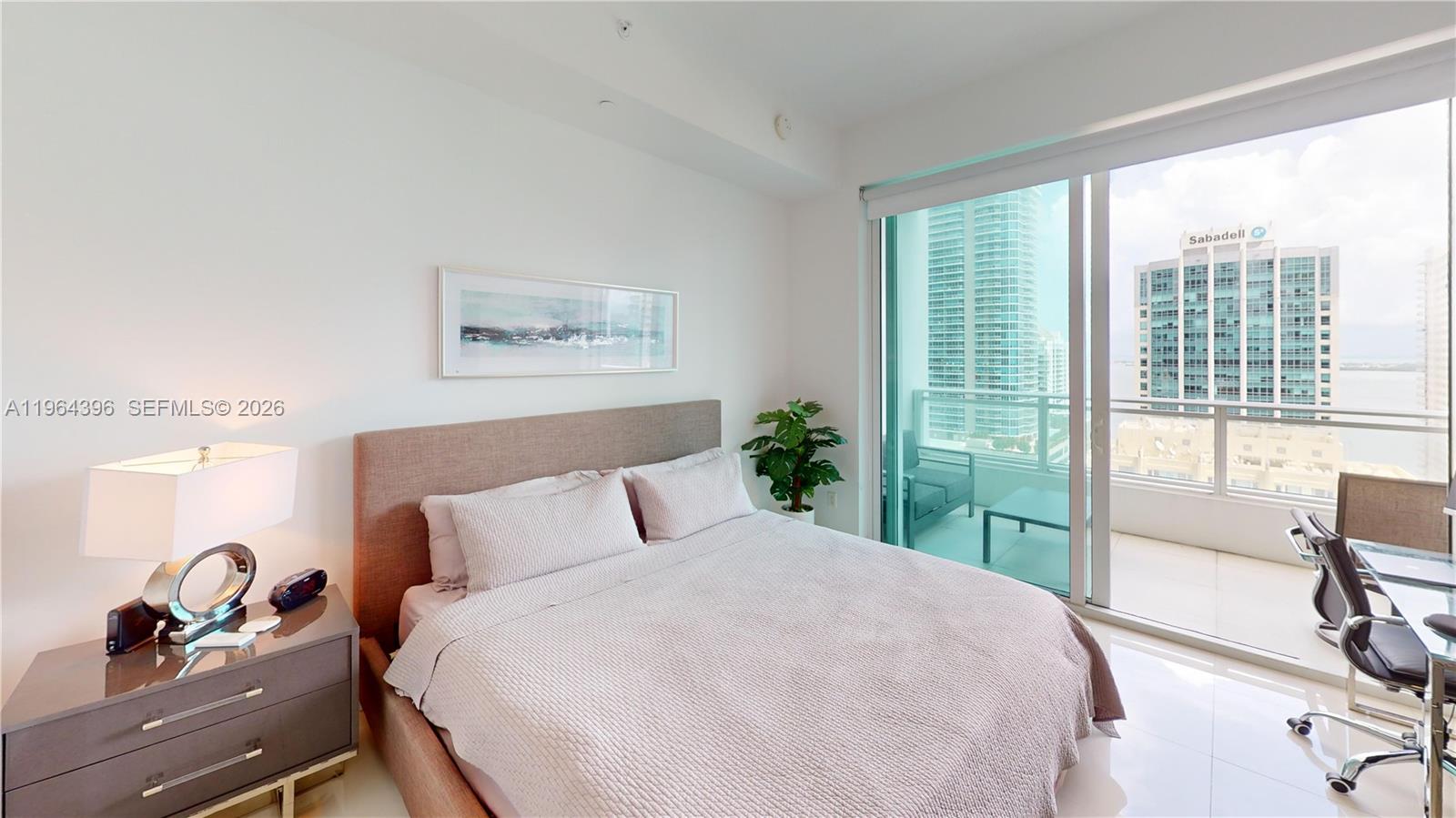 1080 Brickell Avenue, Unit 2804 Miami, FL 33131 - Photo 23 of 35 a bedroom with a bed and wooden floor