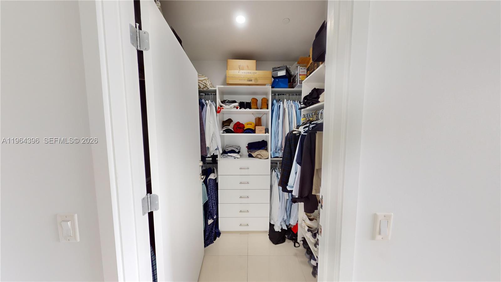 1080 Brickell Avenue, Unit 2804 Miami, FL 33131 - Photo 25 of 35 a view of walk in closet with clothes and shoes