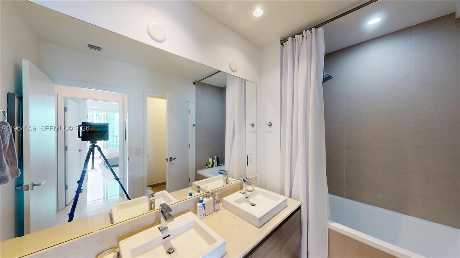 1080 Brickell Avenue, Unit 2804 Miami, FL 33131 - Photo 27 of 35 a view of a hallway with furniture and floor to ceiling window