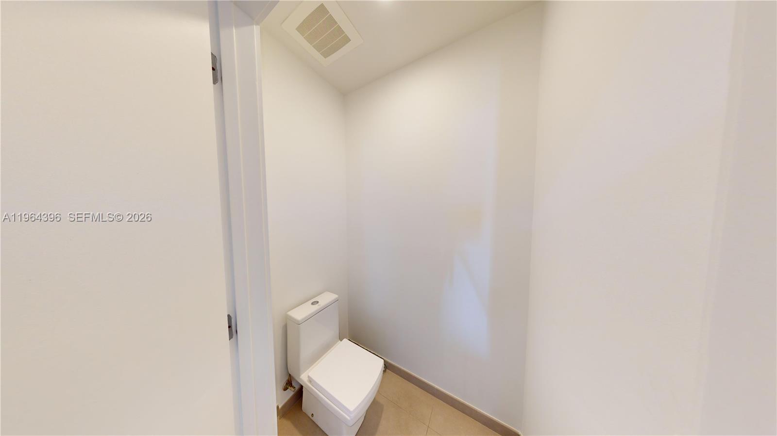 1080 Brickell Avenue, Unit 2804 Miami, FL 33131 - Photo 28 of 35 a white toilet sitting next to a white wall