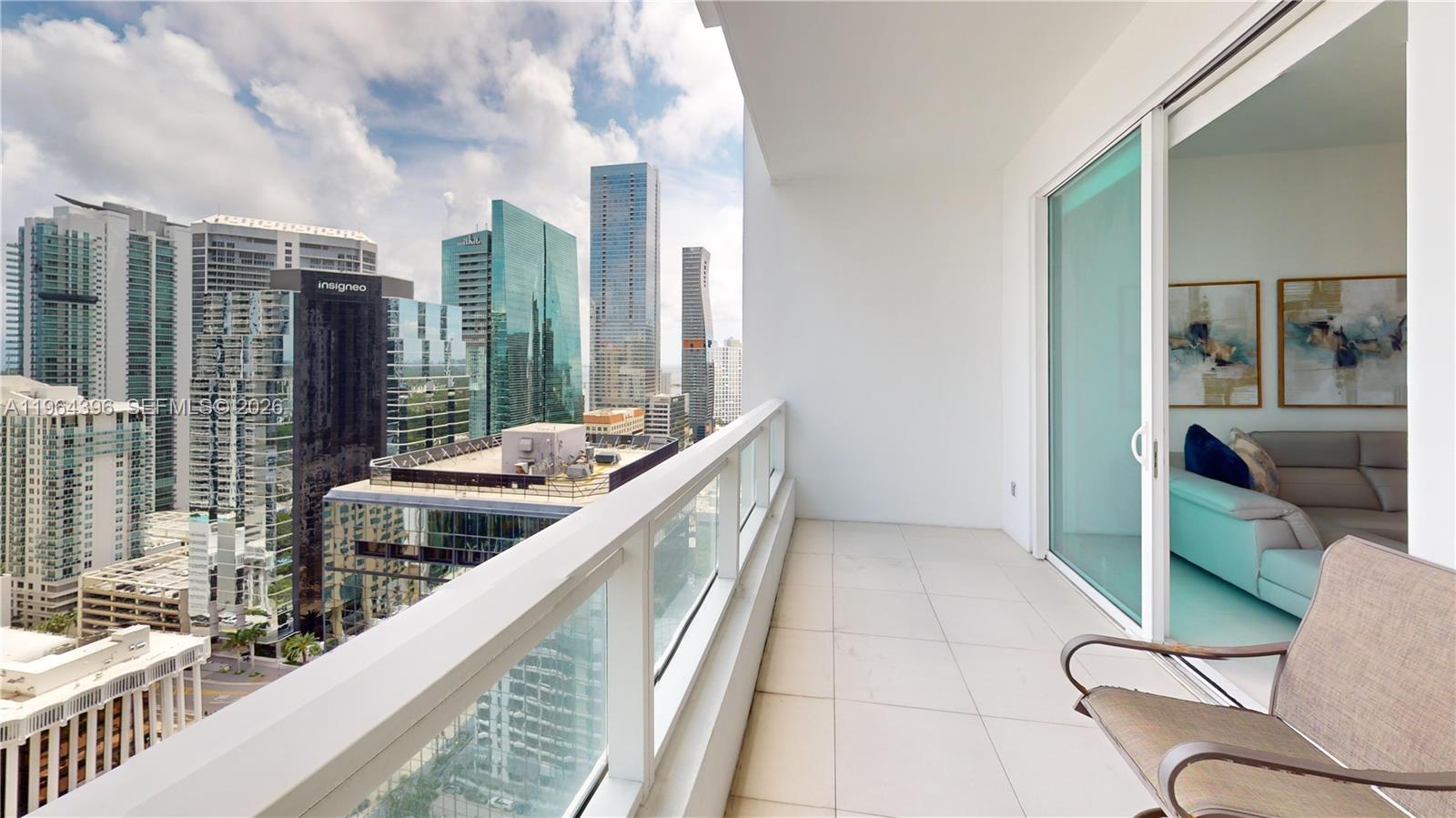 1080 Brickell Avenue, Unit 2804 Miami, FL 33131 - Photo 30 of 35 a balcony with furniture and a large window