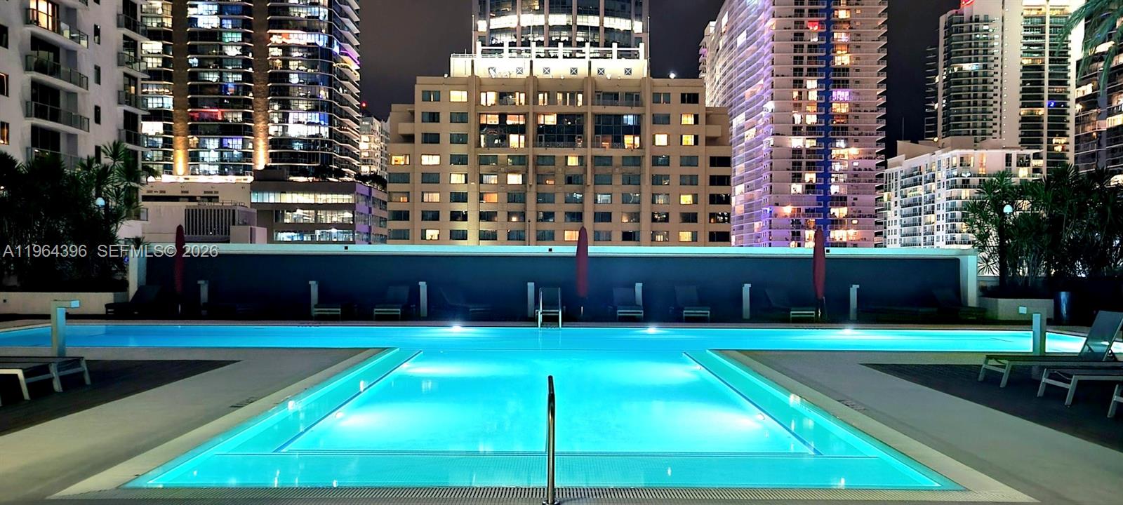 1080 Brickell Avenue, Unit 2804 Miami, FL 33131 - Photo 34 of 35 a swimming pool with buildings in the background