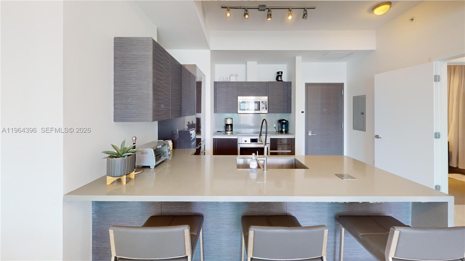 1080 Brickell Avenue, Unit 2804 Miami, FL 33131 - Photo 5 of 35 a kitchen with refrigerator and a sink