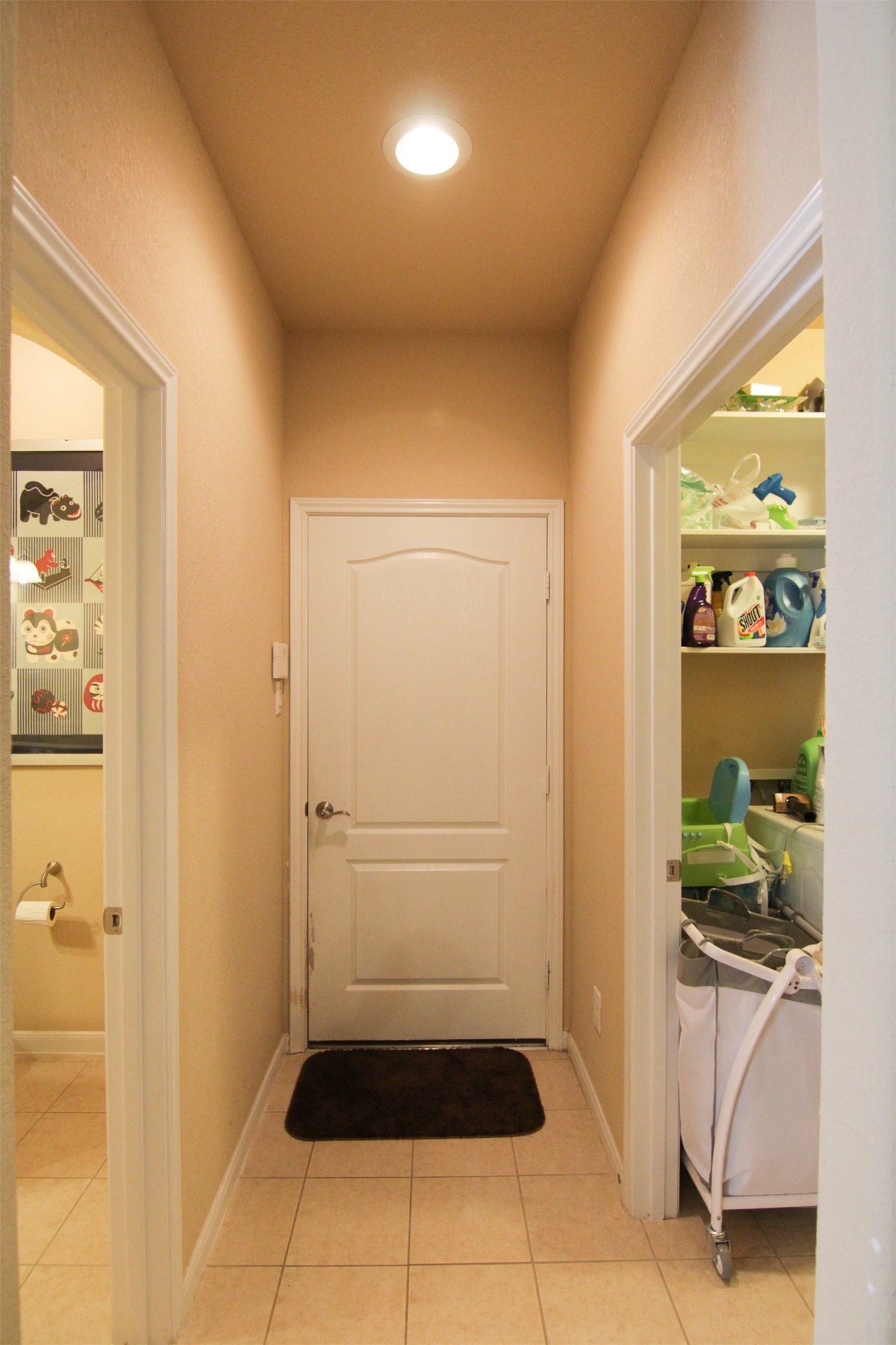 1423 Ralston Branch Way Sugar Land, TX 77479 - Photo 31 of 43 hallway to laundry room on right, powder bath on left, door to garage ahead (washer & dryer not included)