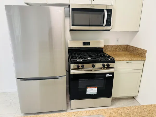 a stove top oven sitting inside of a kitchen