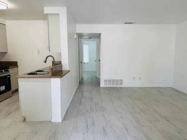 a view of a storage & utility room with closet wooden floor and windows