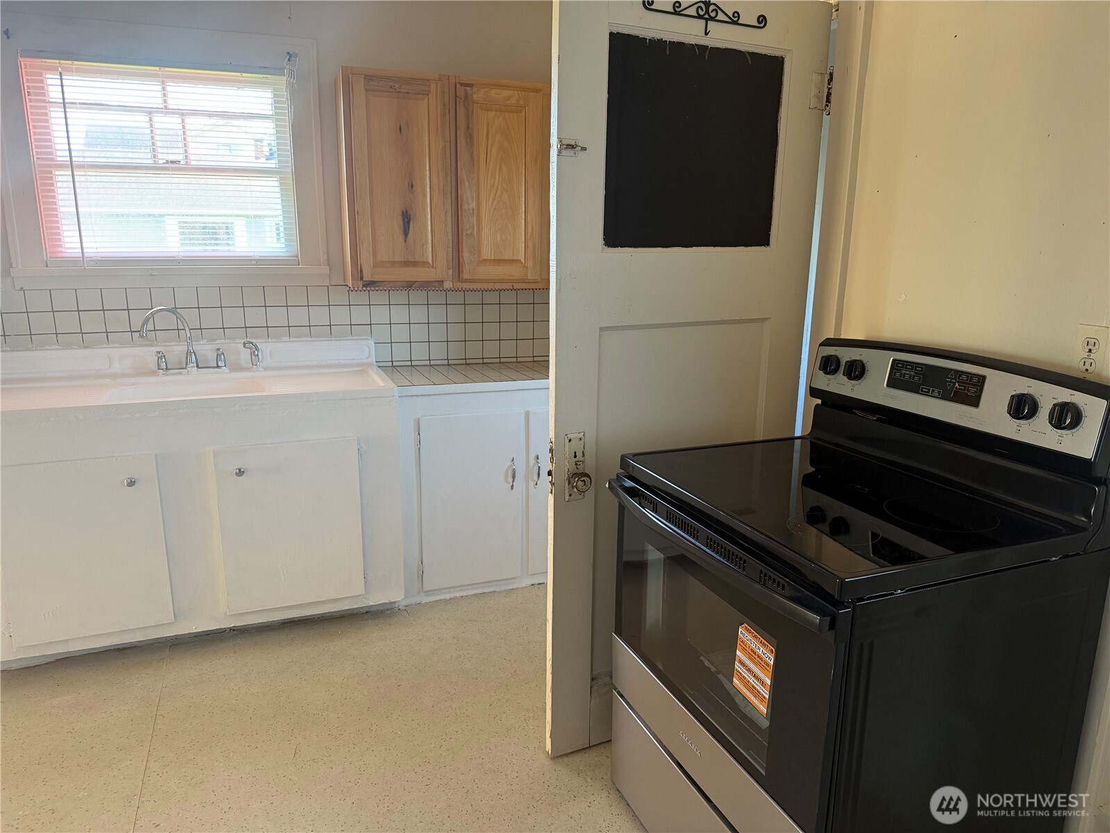 3101 Sumner Avenue Hoquiam, WA 98550 - Photo 16 of 21 a kitchen with a stove and a microwave