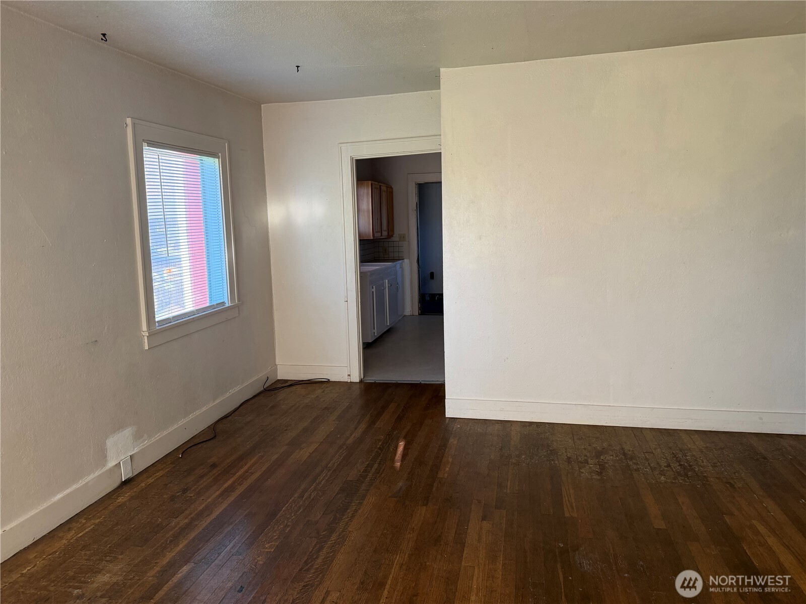 3101 Sumner Avenue Hoquiam, WA 98550 - Photo 6 of 21 a view of an empty room with wooden floor and a window