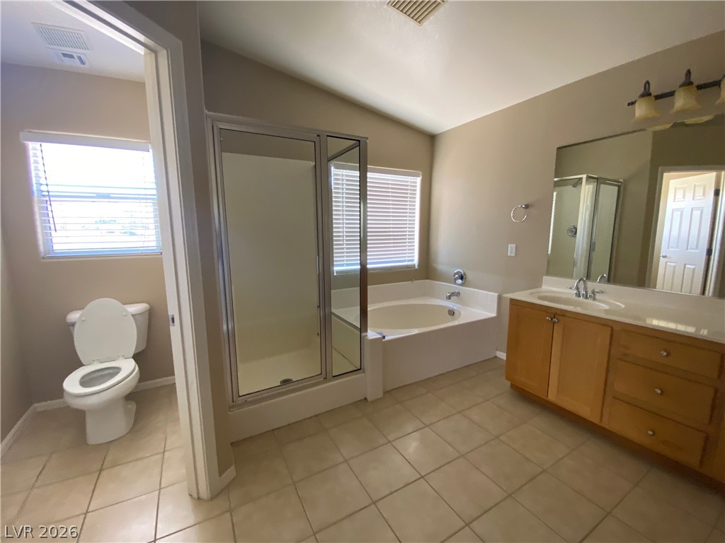 489 Foster Springs Road Las Vegas, NV 89148 - Photo 15 of 30 A well-appointed bath features an ample vanity, glass-enclosed shower, and a relaxing soaking tub.