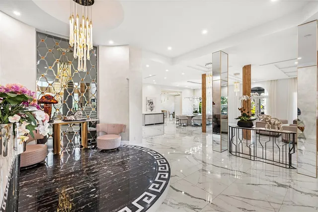 a living room with furniture a rug and white walls