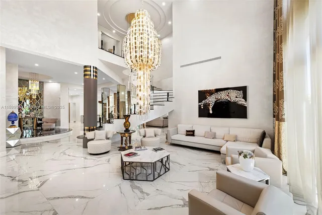 a living room with furniture and floor to ceiling windows