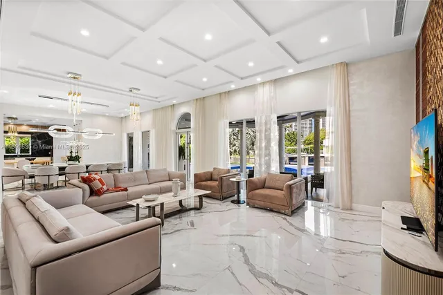 a view of a dining room with furniture a chandelier and wooden floor
