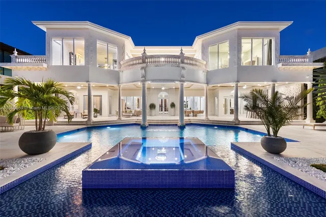 a living room with furniture and a dining table with wooden floor
