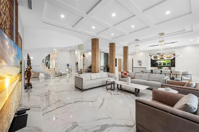 a living room with furniture and a floor to ceiling window