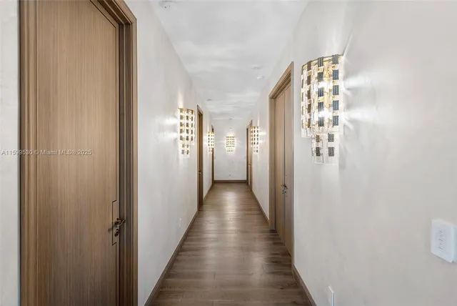 a spacious bedroom with a large bed and a chandelier