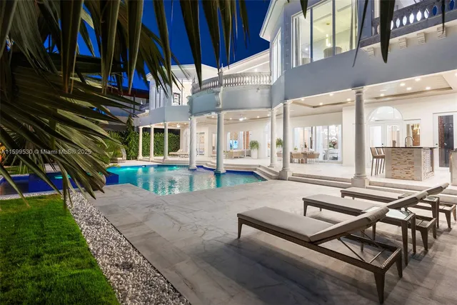a view of a balcony with furniture and floor to ceiling window