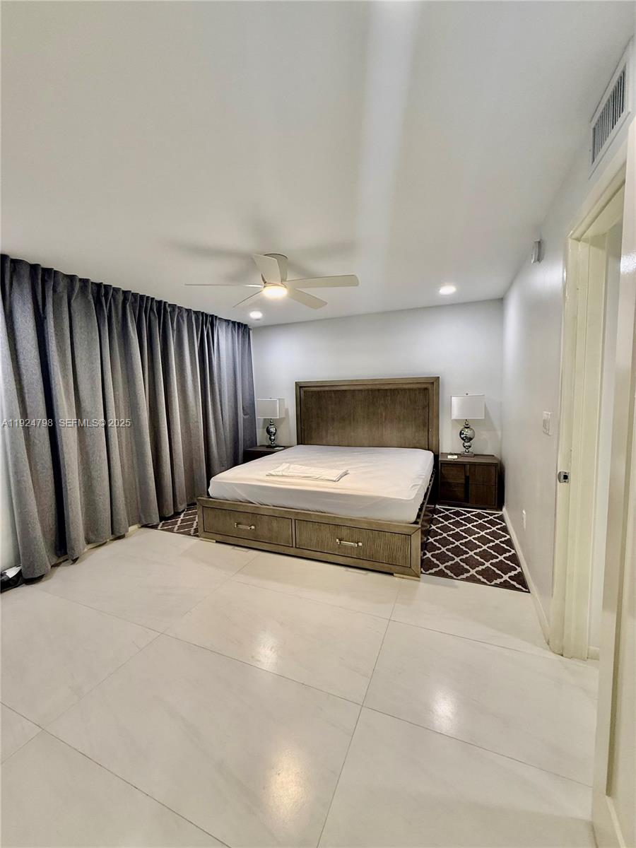 1100 Alton Road, Unit 4D Miami Beach, FL 33139 - Photo 11 of 39 a bedroom with a bed and a cabinets