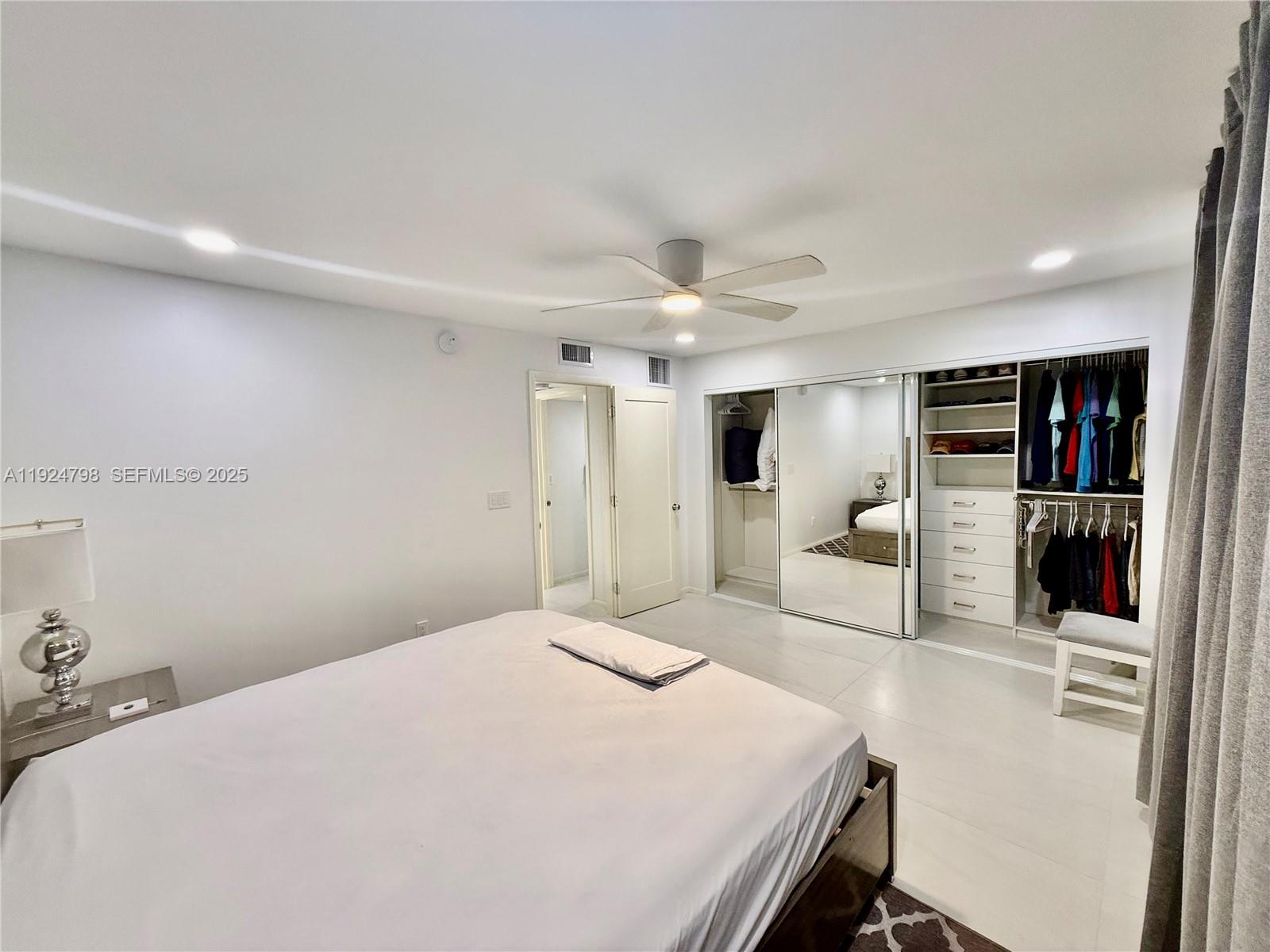 1100 Alton Road, Unit 4D Miami Beach, FL 33139 - Photo 13 of 39 a bedroom with a large bed and a view of kitchen
