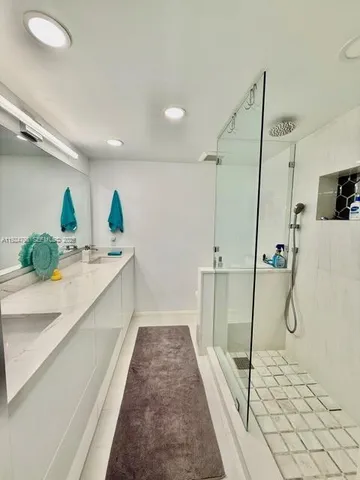 a bathroom with a tub sink and mirror