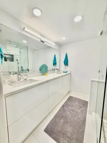 a spacious bathroom with a double vanity sink and a mirror