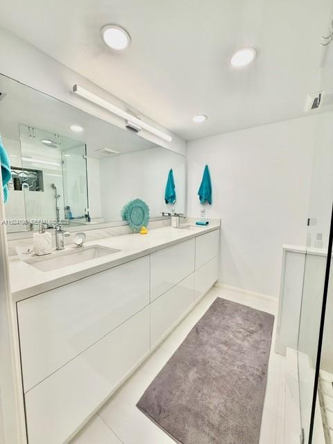 1100 Alton Road, Unit 4D Miami Beach, FL 33139 - Photo 15 of 39 a spacious bathroom with a double vanity sink and a mirror