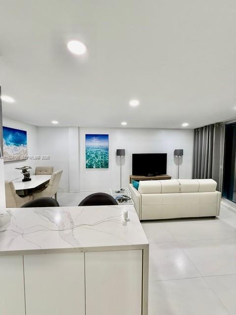 1100 Alton Road, Unit 4D Miami Beach, FL 33139 - Photo 19 of 39 a living room with furniture and a flat screen tv