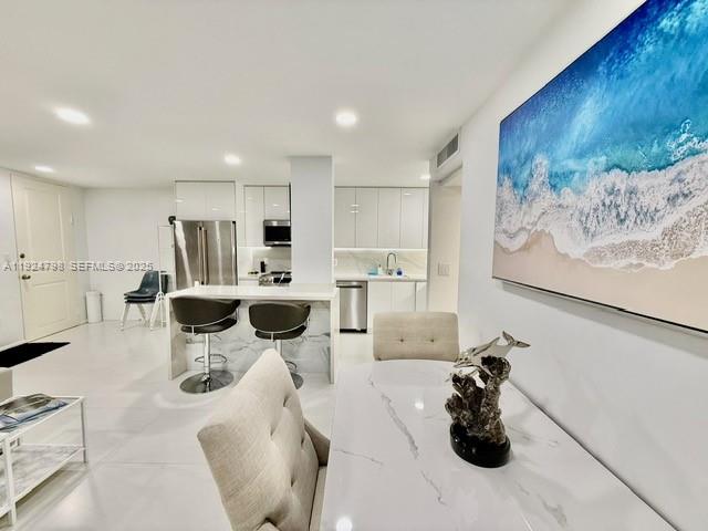 1100 Alton Road, Unit 4D Miami Beach, FL 33139 - Photo 20 of 39 a kitchen with stainless steel appliances kitchen island granite countertop a sink and cabinets