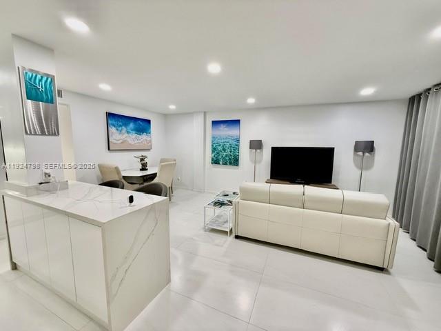 1100 Alton Road, Unit 4D Miami Beach, FL 33139 - Photo 21 of 39 a living room with furniture and a flat screen tv
