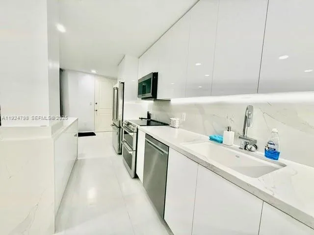 a kitchen with a sink stove and refrigerator