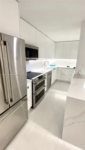 a kitchen with a refrigerator sink and stove