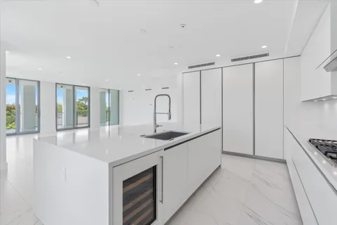 a kitchen with granite countertop white cabinets and stainless steel appliances